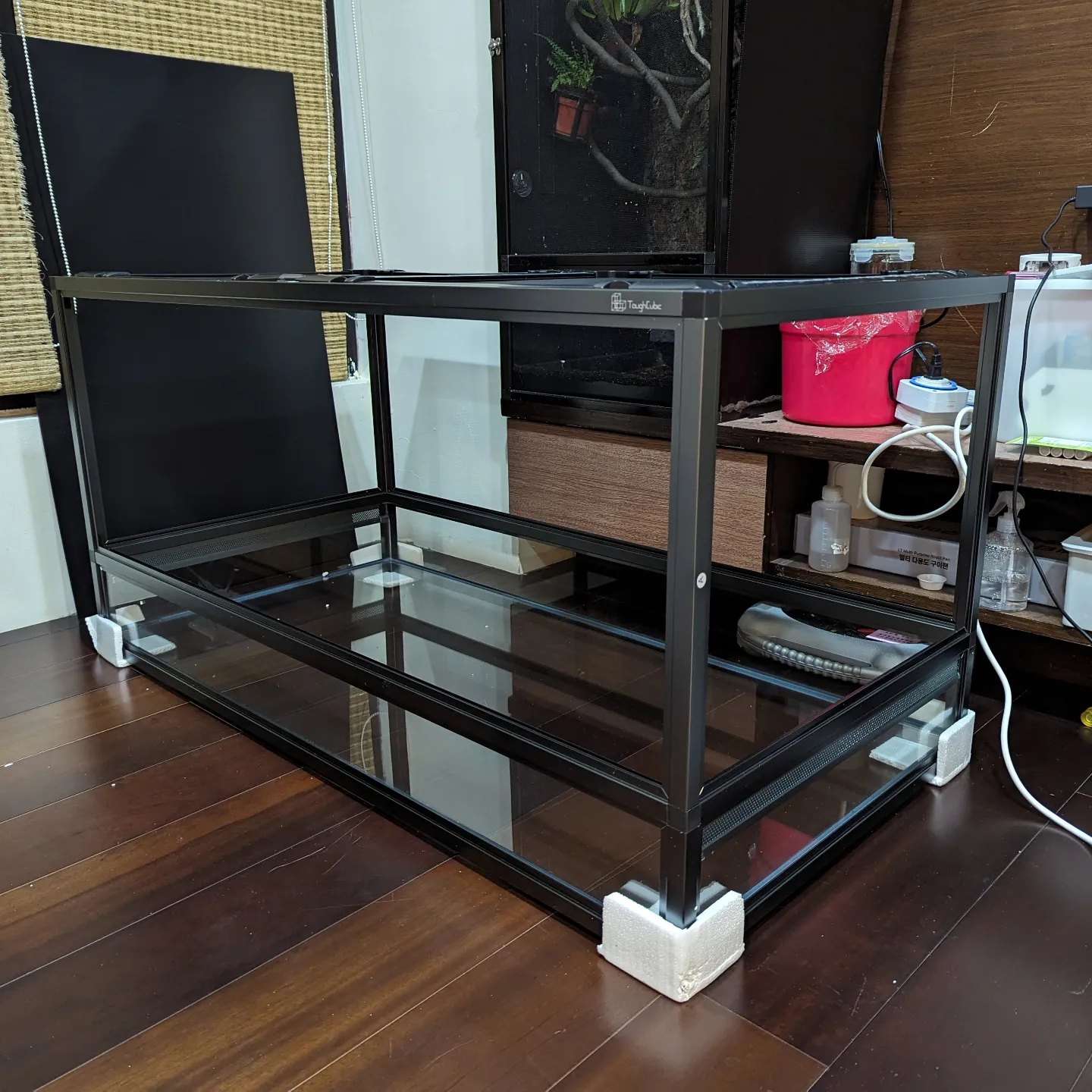組裝好還沒鋪底材的 Tough Cubic 球蟒缸, 黑色鋁合金骨架, 玻璃缸底, 下緣有一整排通風網